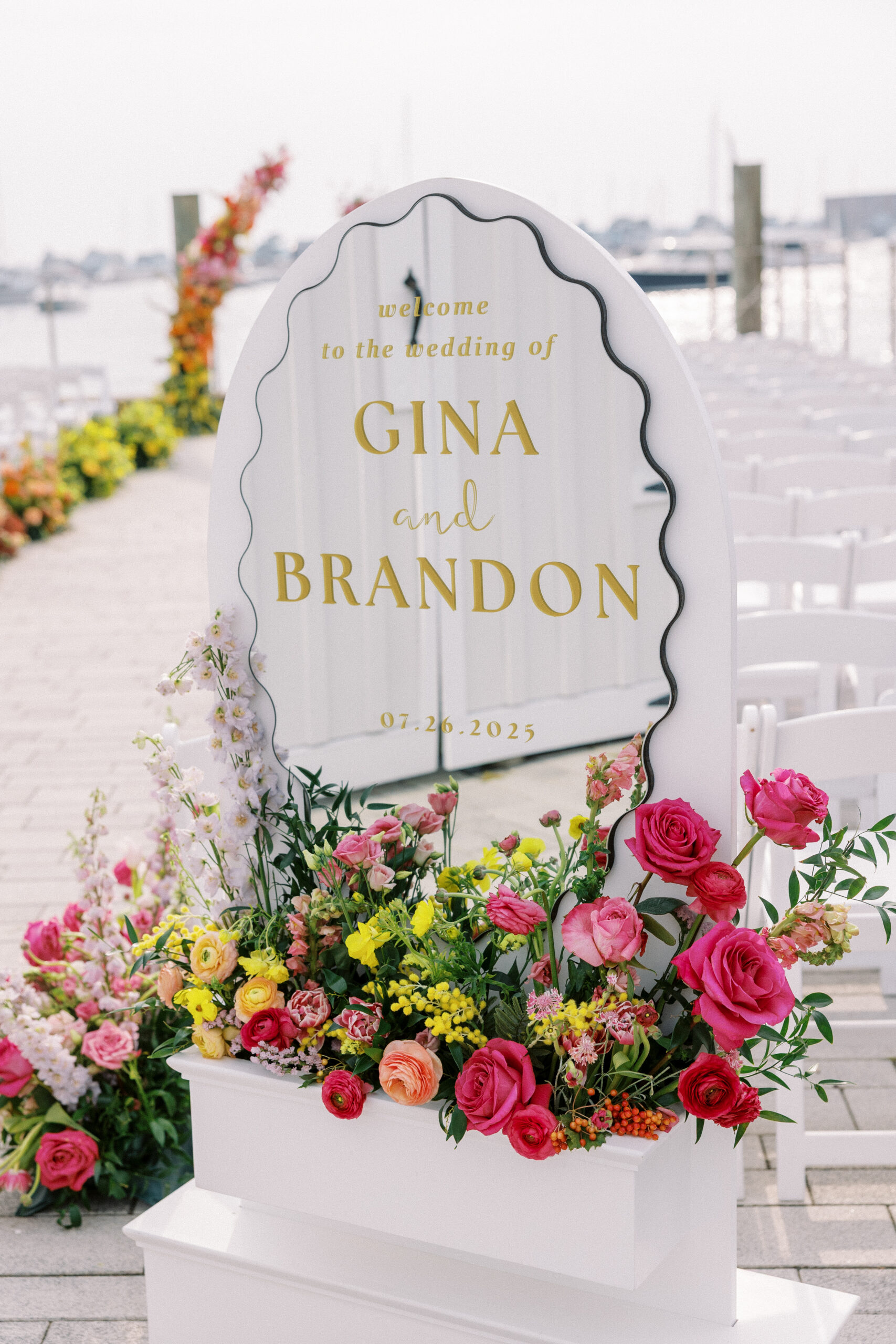 Colorful floral welcome sign at a wedding entrance