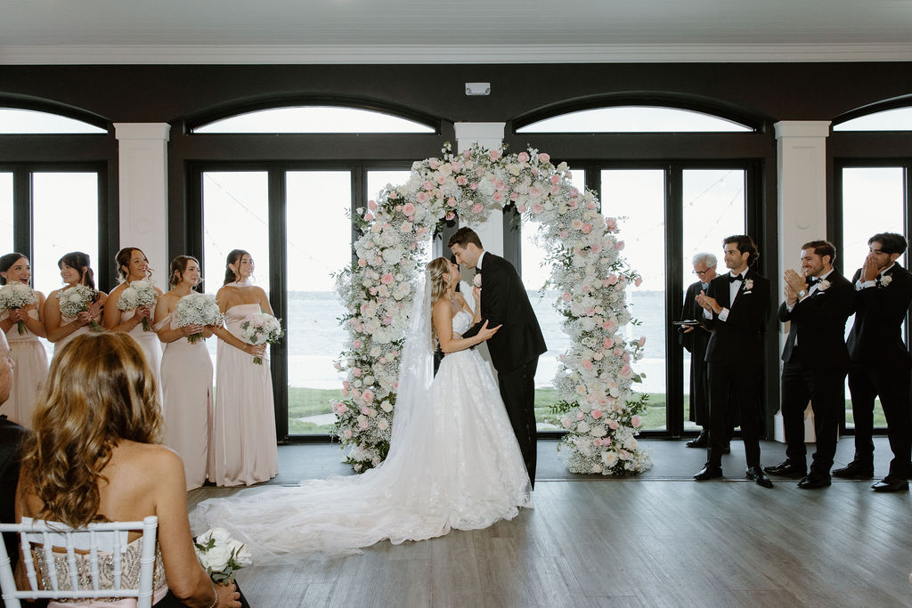 Candlelit rehearsal dinner table styled with soft florals for a Palm Beach wedding weekend